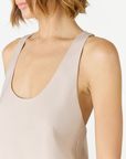 Discover luxury with the Anaiis Silk Tank in champagne cream from AOCO. Crafted from premium silk, this chic and versatile camisole offers a flawless drape for any occasion. And Racerback feature.
