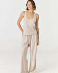 Discover luxury with the Anaiis Silk Tank in champagne cream from AOCO. Crafted from premium silk, this chic and versatile camisole offers a flawless drape for any occasion. And Racerback feature.