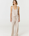 Discover luxury with the Anaiis Silk Tank in champagne cream from AOCO. Crafted from premium silk, this chic and versatile camisole offers a flawless drape for any occasion. And Racerback feature.