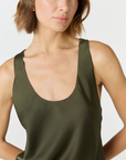 Discover luxury with the Anaiis Silk Tank in olive from AOCO. Crafted from premium silk, this chic and versatile camisole offers a flawless drape for any occasion. And Racerback feature.