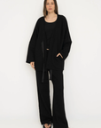 Wrap yourself in comfort with the French Terry Robe Jacket from AOCO. This versatile layer blends robe-like coziness with an everyday stylish jacket design.