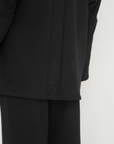 Wrap yourself in comfort with the French Terry Robe Jacket from AOCO. This versatile layer blends robe-like coziness with an everyday stylish jacket design.