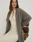 Stay warm and stylish with the Cashmere Wool Blend Cardigan by AOCO. This luxurious, ultra-soft knit sweater provides a cozy, elegant layering essential.