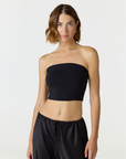 Elevate your warm-weather wardrobe with the Edie Bandeau Top in Black from AOCO. This chic strapless design offers a flattering fit and endless style possibilities.