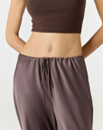 Experience ultimate comfort and sophistication with the Gia Silk Pants in brown by AOCO. These luxury trousers offer a flattering fit and an elegant, flawless drape.