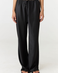 Experience ultimate comfort and sophistication with the Gia Silk Pants in black by AOCO. These luxury trousers offer a flattering fit and an elegant, flawless drape.