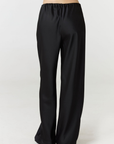 Experience ultimate comfort and sophistication with the Gia Silk Pants in black by AOCO. These luxury trousers offer a flattering fit and an elegant, flawless drape.