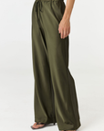 Experience ultimate comfort and sophistication with the Gia Silk Pants in olive by AOCO. These luxury trousers offer a flattering fit and an elegant, flawless drape.