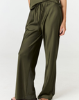 Experience ultimate comfort and sophistication with the Gia Silk Pants in olive by AOCO. These luxury trousers offer a flattering fit and an elegant, flawless drape.