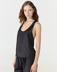 Discover luxury with the Anaiis Silk Tank in black from AOCO. Crafted from premium silk, this chic and versatile camisole offers a flawless drape for any occasion. And Racerback feature.