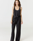 Discover luxury with the Anaiis Silk Tank in black from AOCO. Crafted from premium silk, this chic and versatile camisole offers a flawless drape for any occasion. And Racerback feature.
