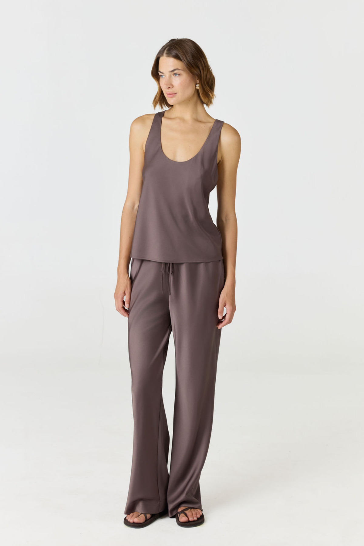 Discover luxury with the Anaiis Silk Tank from AOCO. Crafted from premium silk, this chic and versatile camisole offers a flawless drape for any occasion. And Racerback feature.