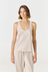 Discover luxury with the Anaiis Silk Tank in champagne cream from AOCO. Crafted from premium silk, this chic and versatile camisole offers a flawless drape for any occasion. And Racerback feature.