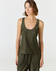 Discover luxury with the Anaiis Silk Tank in olive from AOCO. Crafted from premium silk, this chic and versatile camisole offers a flawless drape for any occasion. And Racerback feature.