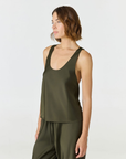 Discover luxury with the Anaiis Silk Tank in olive from AOCO. Crafted from premium silk, this chic and versatile camisole offers a flawless drape for any occasion. And Racerback feature.