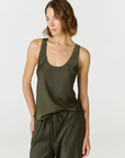 Discover luxury with the Anaiis Silk Tank in olive from AOCO. Crafted from premium silk, this chic and versatile camisole offers a flawless drape for any occasion. And Racerback feature.