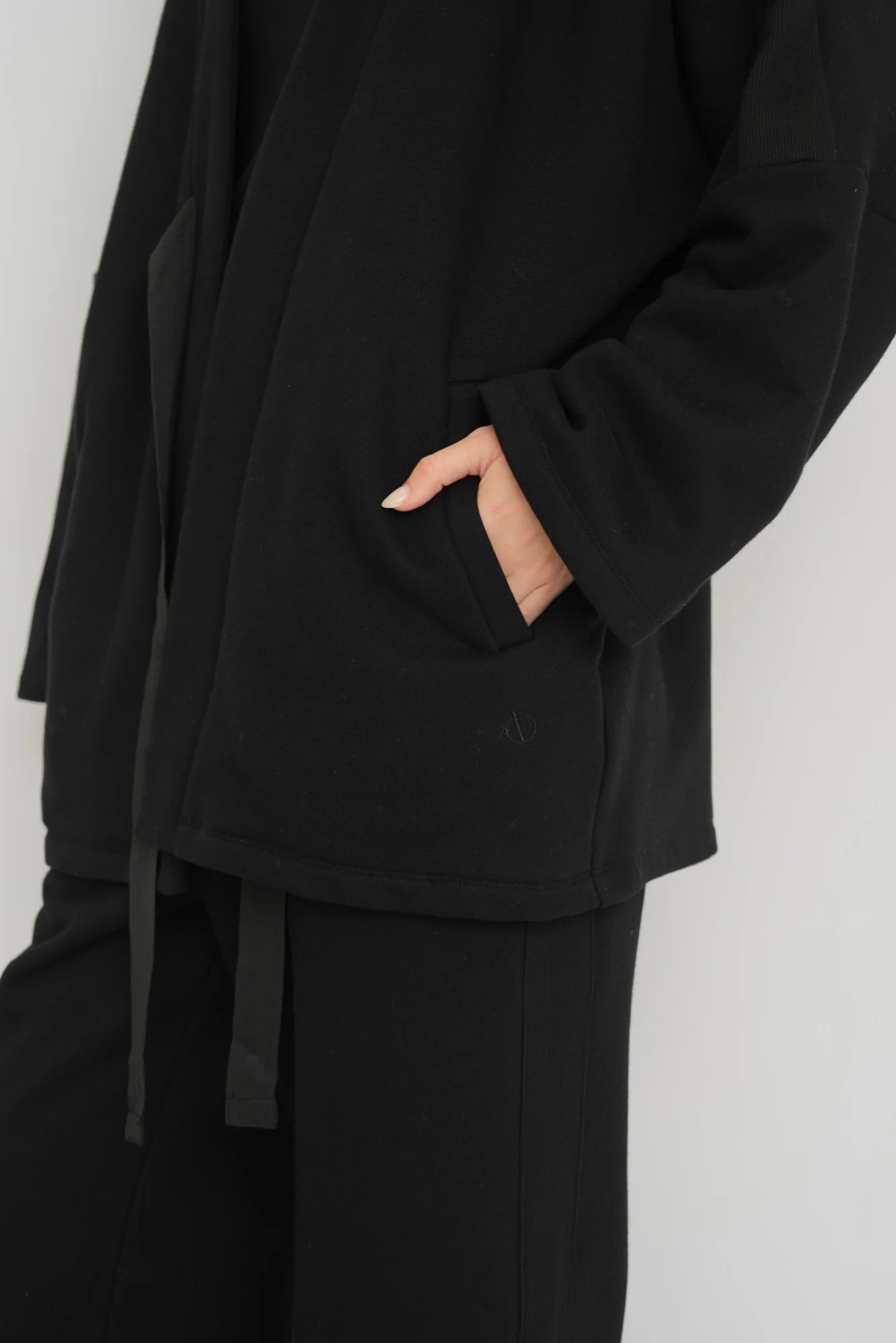 Wrap yourself in comfort with the French Terry Robe Jacket from AOCO. This versatile layer blends robe-like coziness with an everyday stylish jacket design.