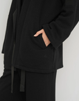 Wrap yourself in comfort with the French Terry Robe Jacket from AOCO. This versatile layer blends robe-like coziness with an everyday stylish jacket design.