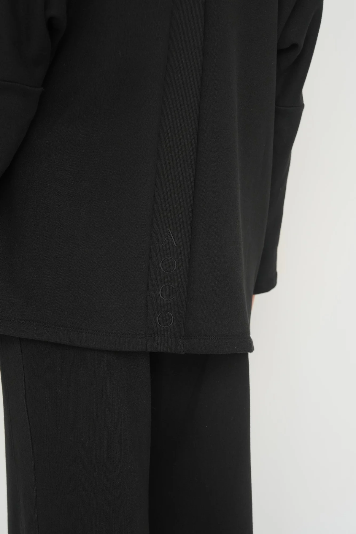 Wrap yourself in comfort with the French Terry Robe Jacket from AOCO. This versatile layer blends robe-like coziness with an everyday stylish jacket design.