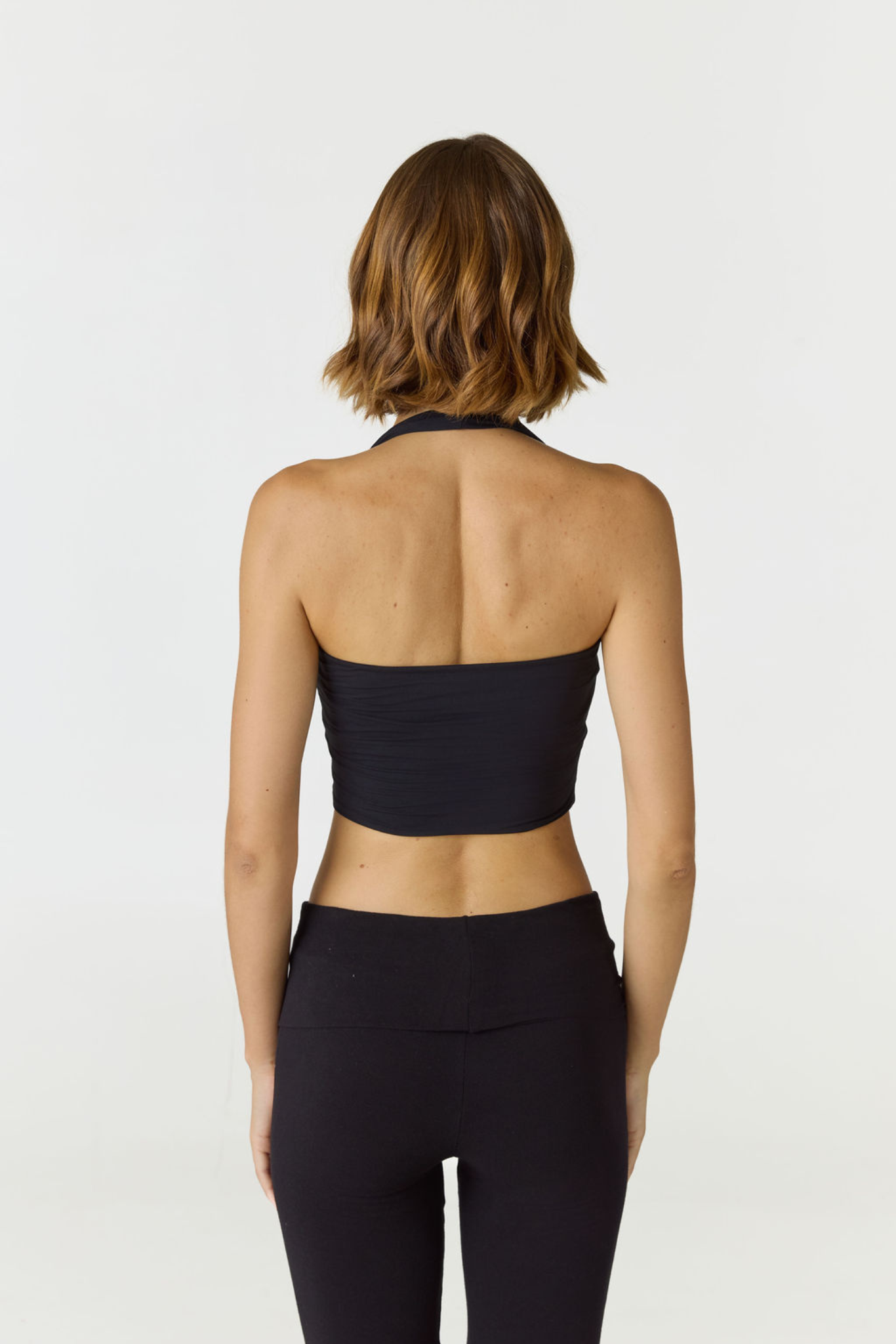 Refresh your summer wardrobe with the Mia Cropped Halter from AOCO. Featuring a chic halter neckline and a flattering cropped fit, it's a warm weather must.