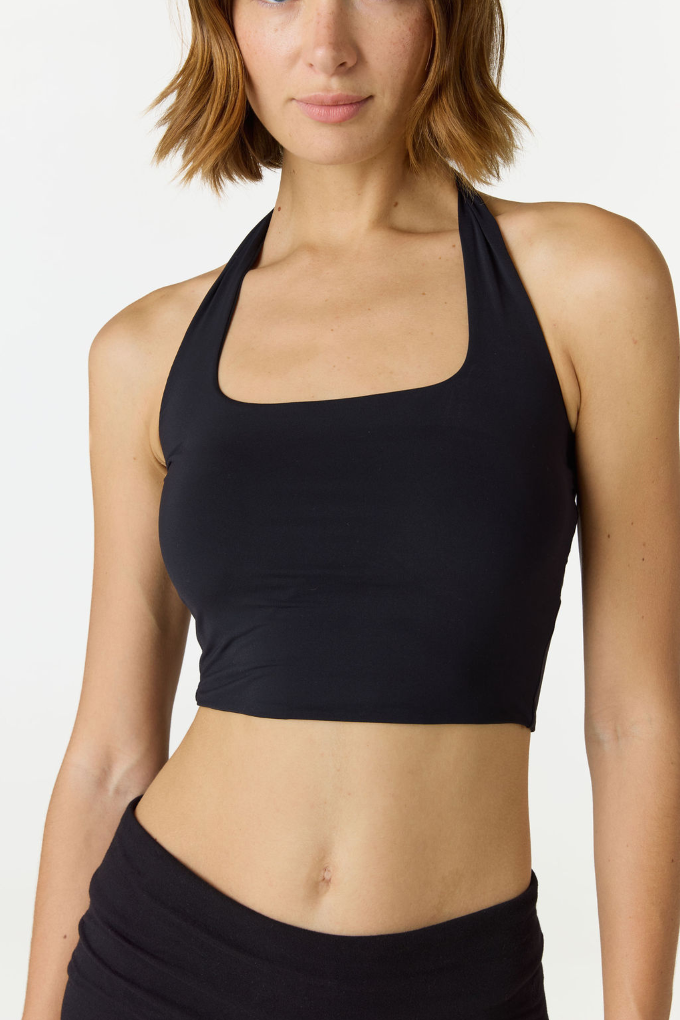 Refresh your summer wardrobe with the Mia Cropped Halter from AOCO. Featuring a chic halter neckline and a flattering cropped fit, it's a warm weather must.