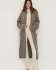 Stay warm and stylish with the Cashmere Wool Blend Cardigan by AOCO. This luxurious, ultra-soft knit sweater provides a cozy, elegant layering essential.