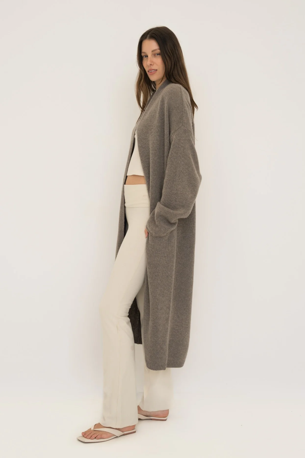 Stay warm and stylish with the Cashmere Wool Blend Cardigan by AOCO. This luxurious, ultra-soft knit sweater provides a cozy, elegant layering essential.