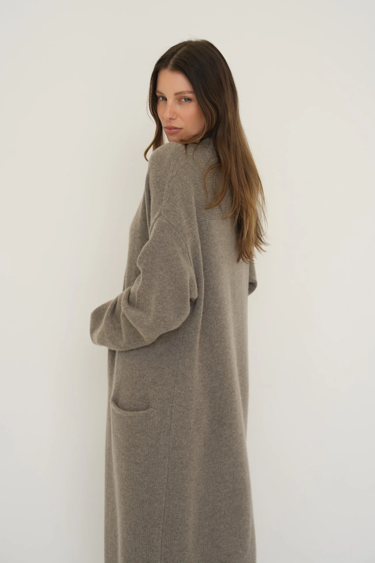 Stay warm and stylish with the Cashmere Wool Blend Cardigan by AOCO. This luxurious, ultra-soft knit sweater provides a cozy, elegant layering essential.