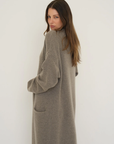 Stay warm and stylish with the Cashmere Wool Blend Cardigan by AOCO. This luxurious, ultra-soft knit sweater provides a cozy, elegant layering essential.