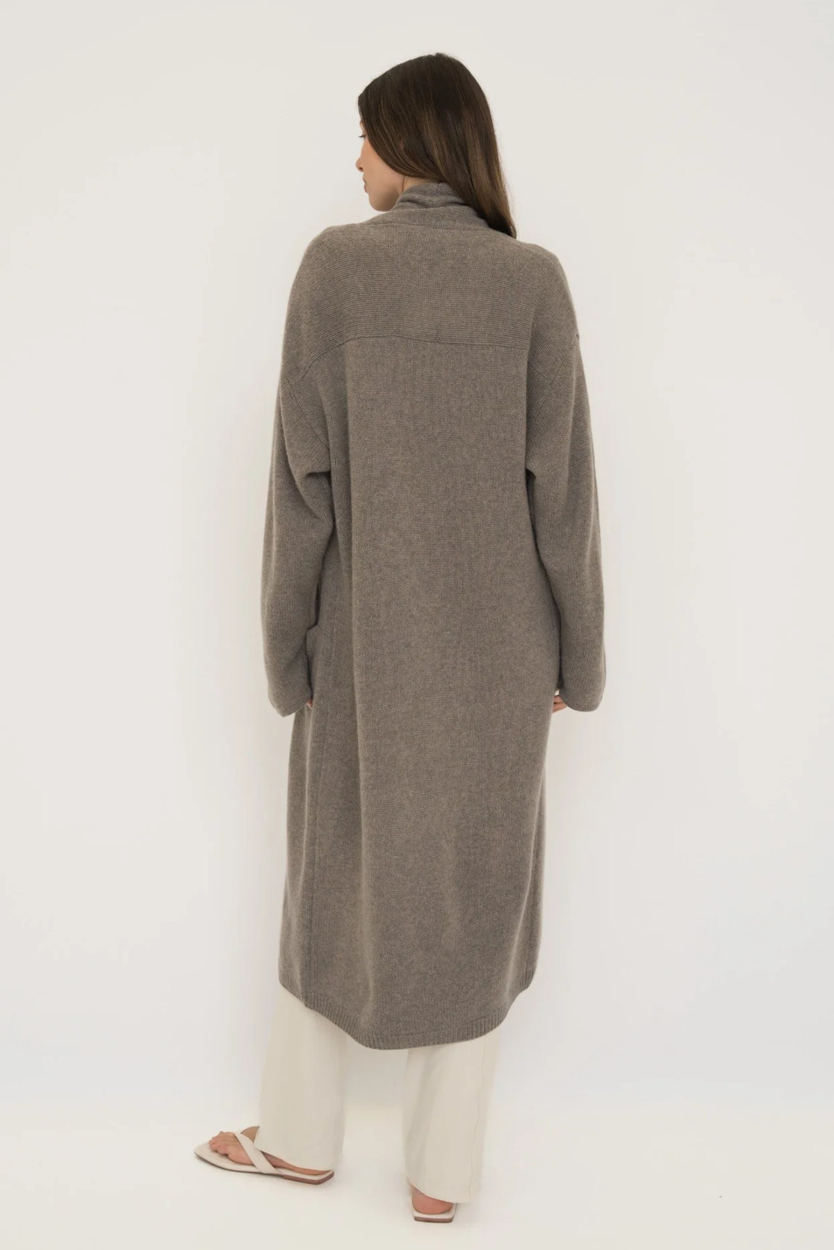 Stay warm and stylish with the Cashmere Wool Blend Cardigan by AOCO. This luxurious, ultra-soft knit sweater provides a cozy, elegant layering essential.