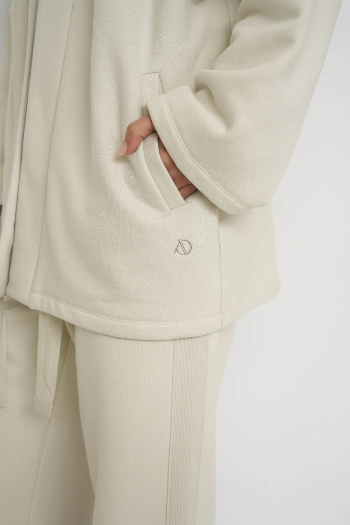 Wrap yourself in comfort with the French Terry Robe Jacket from AOCO. This versatile layer blends robe-like coziness with an everyday stylish jacket design.