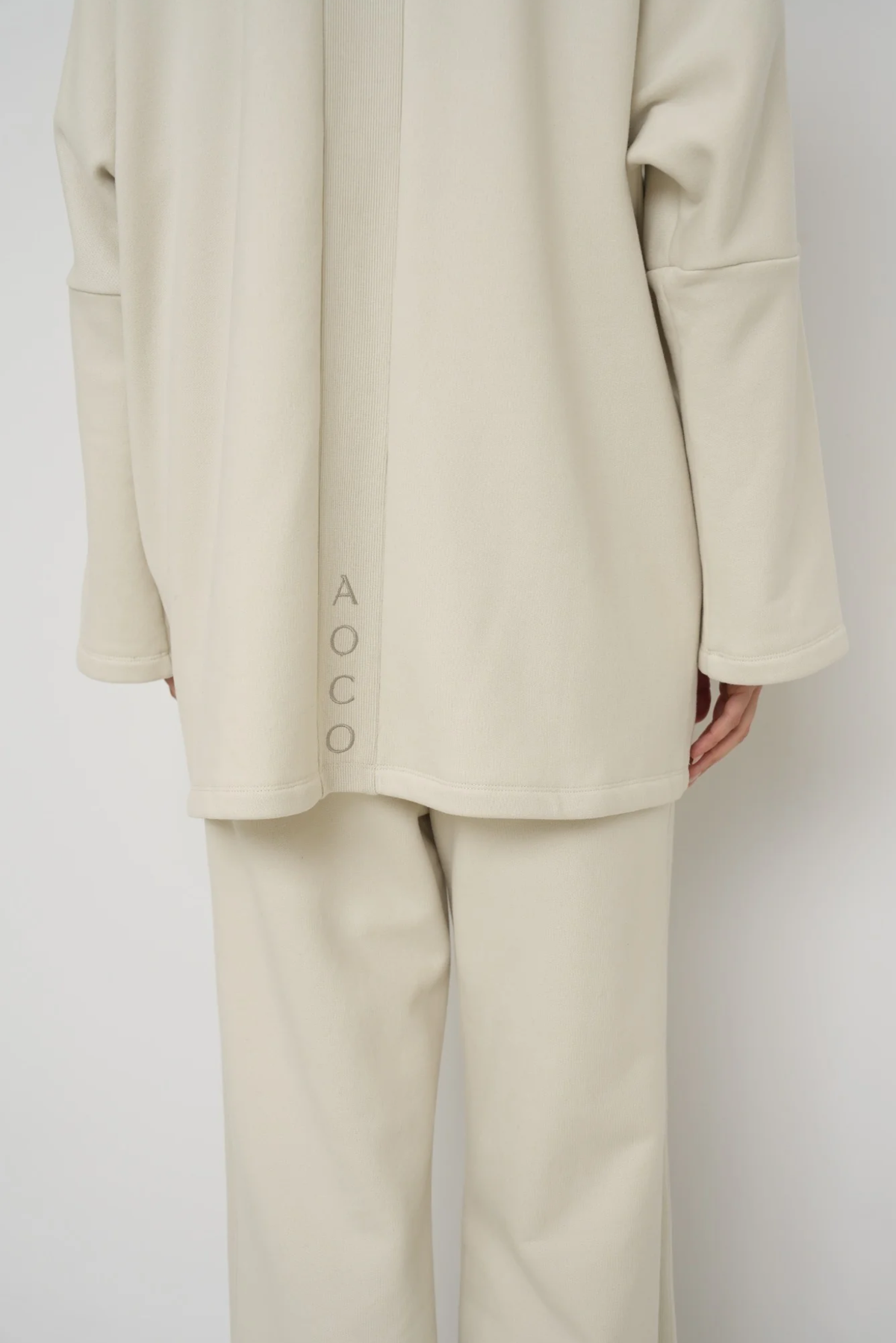 Wrap yourself in comfort with the French Terry Robe Jacket from AOCO. This versatile layer blends robe-like coziness with an everyday stylish jacket design.