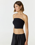 Elevate your warm-weather wardrobe with the Edie Bandeau Top in Black from AOCO. This chic strapless design offers a flattering fit and endless style possibilities.