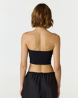 Elevate your warm-weather wardrobe with the Edie Bandeau Top in Black from AOCO. This chic strapless design offers a flattering fit and endless style possibilities.