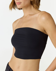 Elevate your warm-weather wardrobe with the Edie Bandeau Top in Black from AOCO. This chic strapless design offers a flattering fit and endless style possibilities.