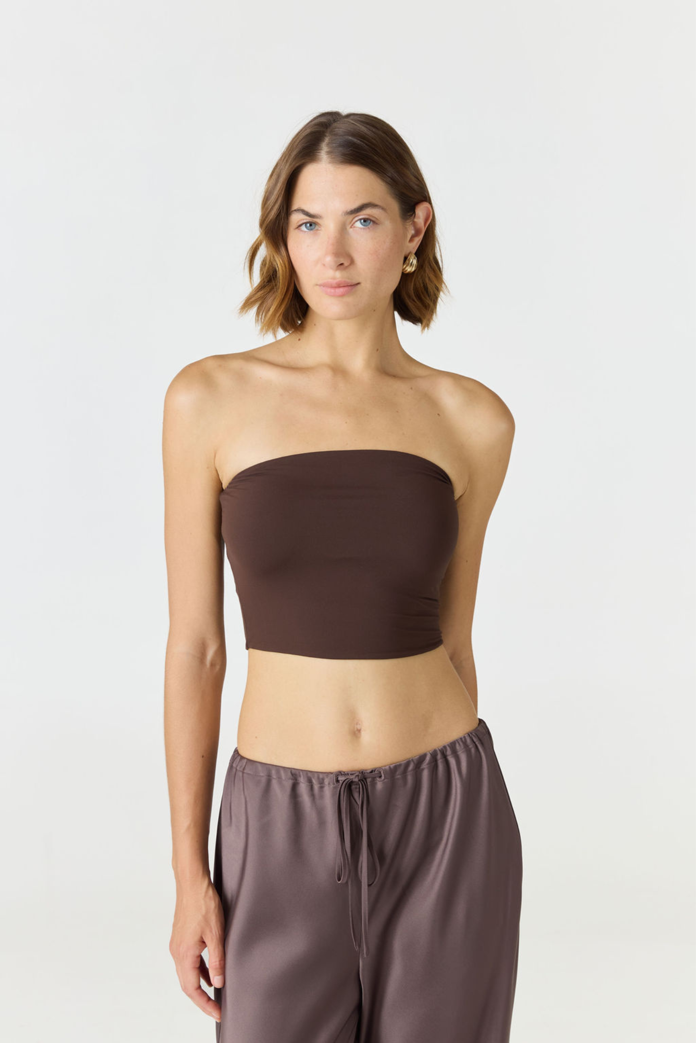 Elevate your warm-weather wardrobe with the Edie Bandeau Top from AOCO. This chic strapless design offers a flattering fit and endless style possibilities.