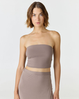 Elevate your warm-weather wardrobe with the Edie Bandeau Top in Taupe from AOCO. This chic strapless design offers a flattering fit and endless style possibilities.