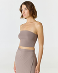 Elevate your warm-weather wardrobe with the Edie Bandeau Top in Taupe from AOCO. This chic strapless design offers a flattering fit and endless style possibilities.