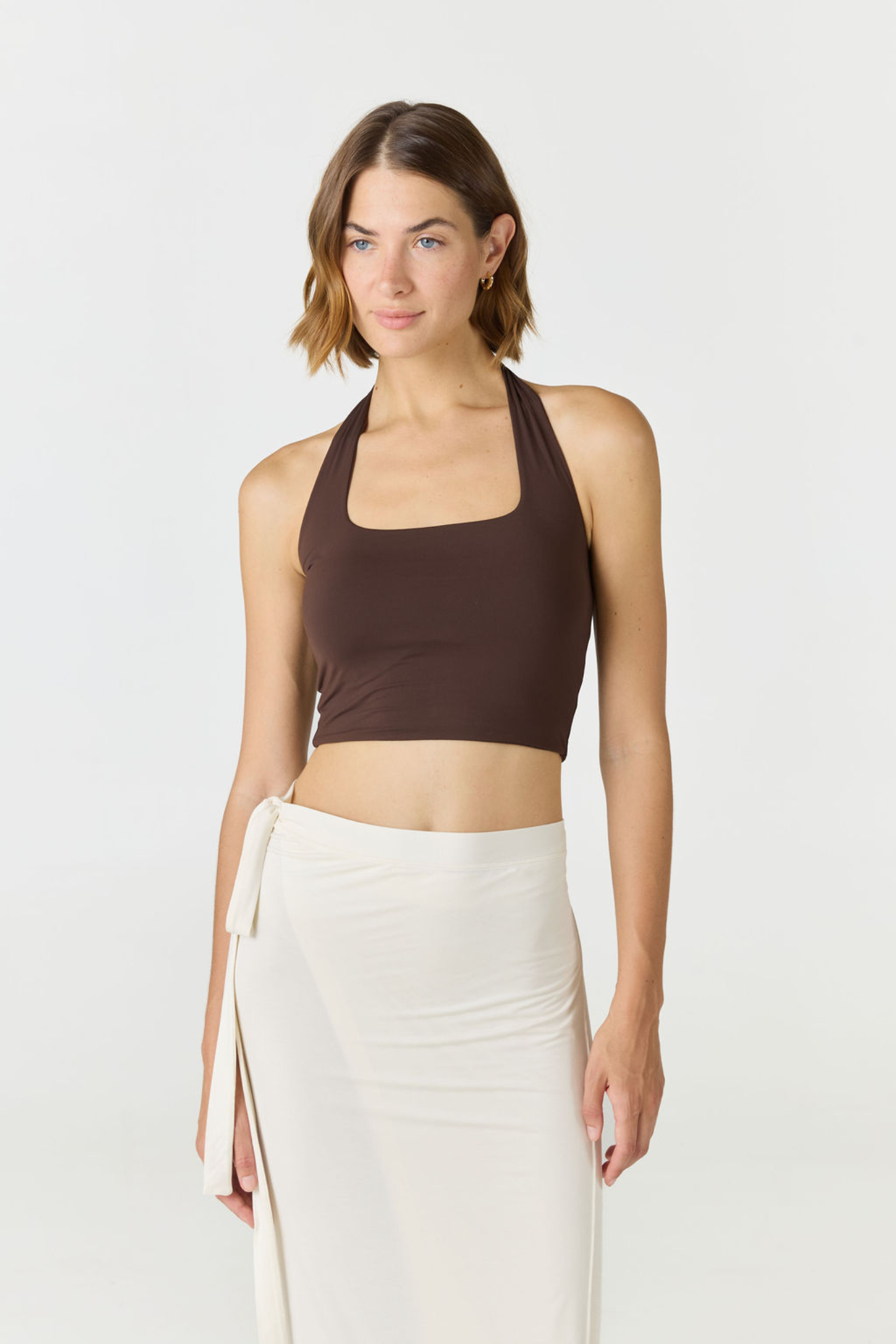 Refresh your summer wardrobe with the Mia Cropped Halter from AOCO. Featuring a chic halter neckline and a flattering cropped fit, it's a warm weather must.
