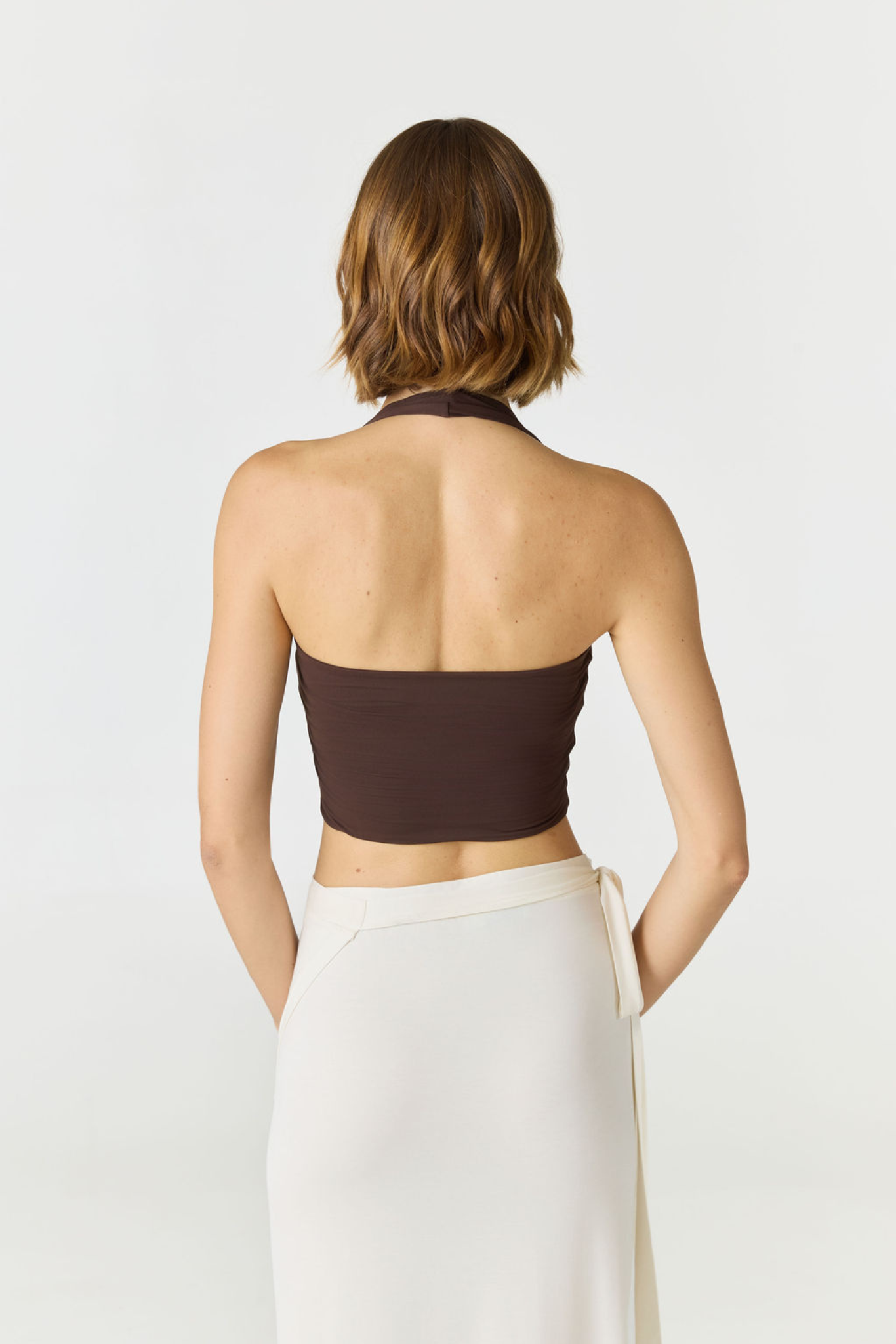 Refresh your summer wardrobe with the Mia Cropped Halter from AOCO. Featuring a chic halter neckline and a flattering cropped fit, it's a warm weather must.