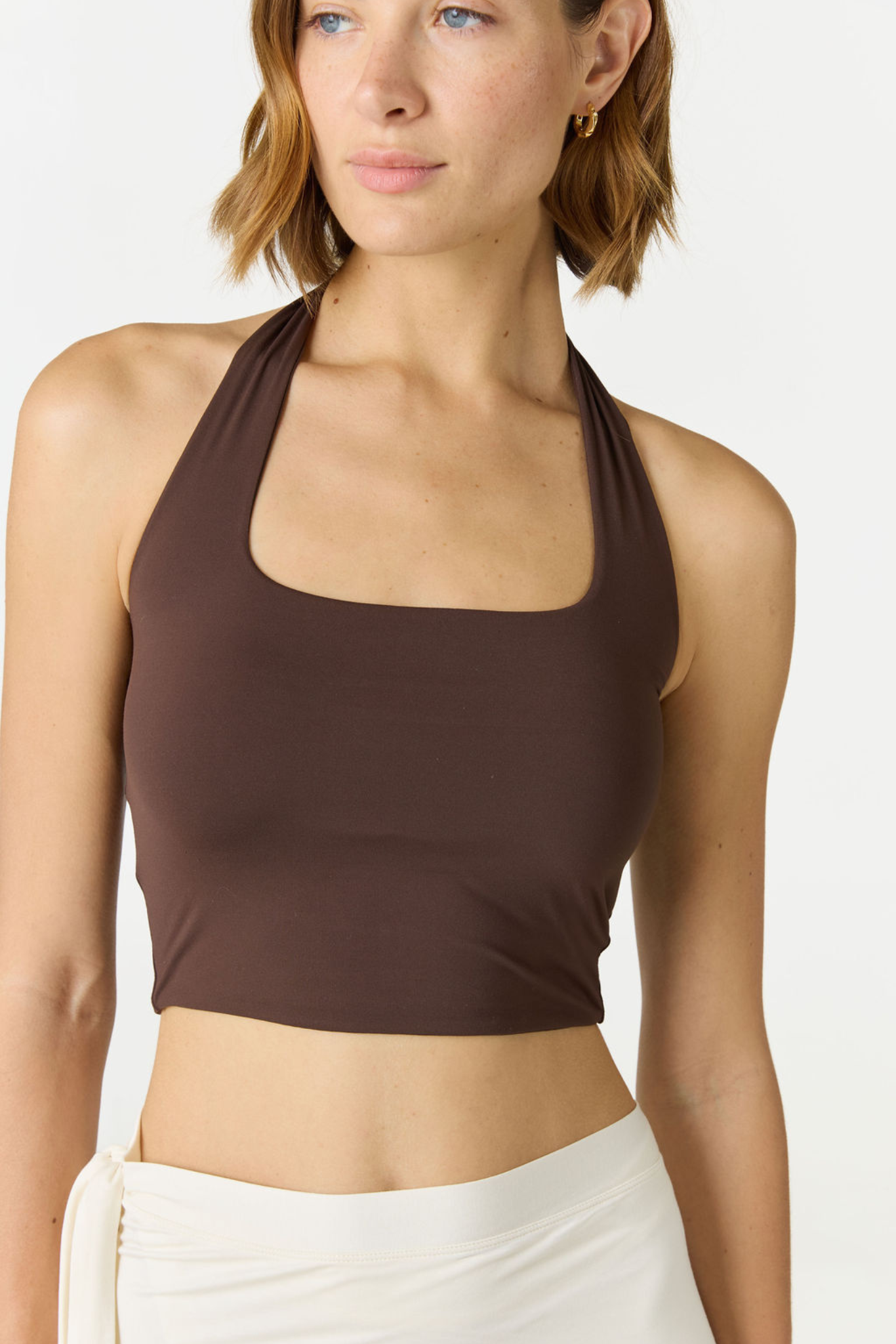 Refresh your summer wardrobe with the Mia Cropped Halter from AOCO. Featuring a chic halter neckline and a flattering cropped fit, it's a warm weather must.
