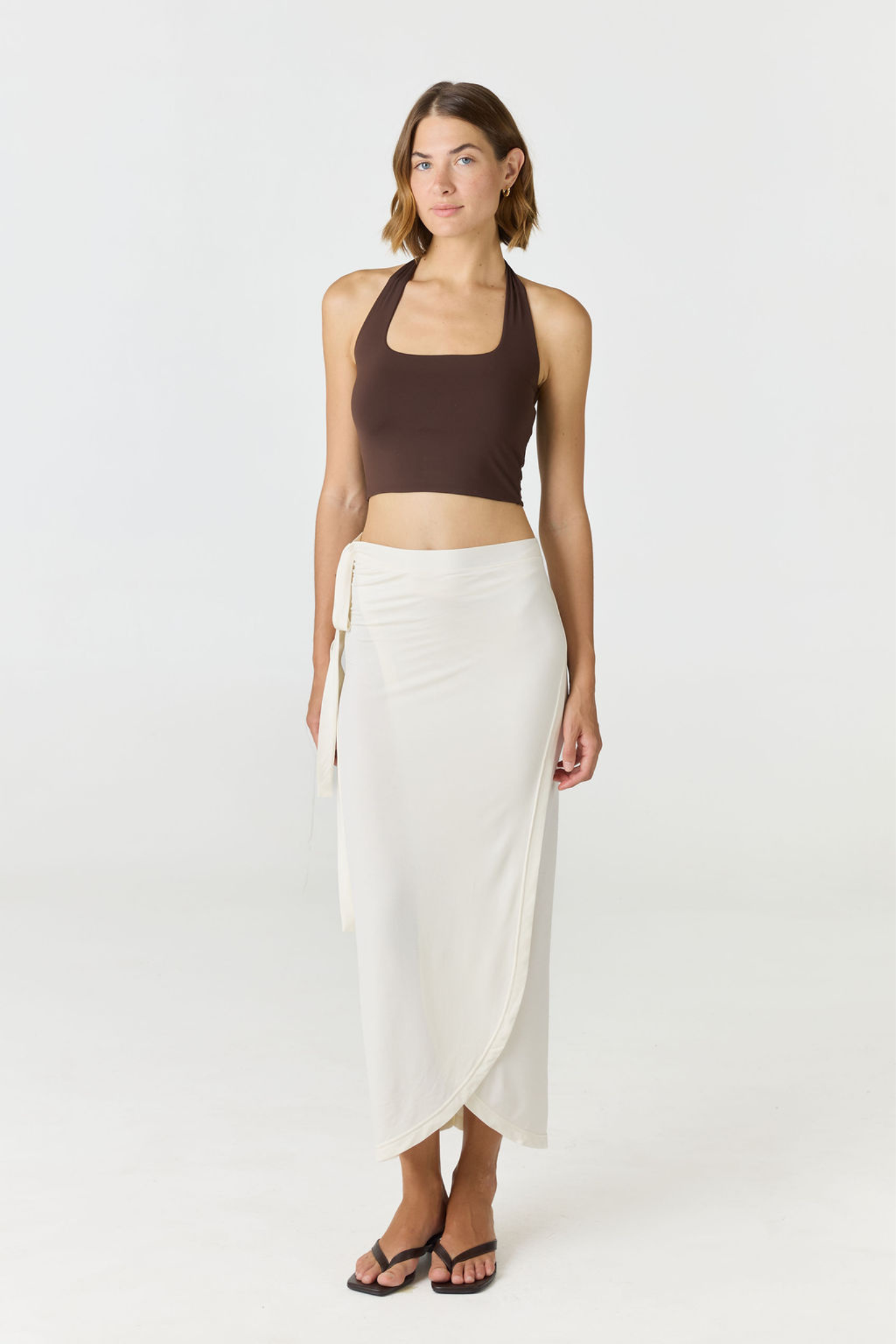 Refresh your summer wardrobe with the Mia Cropped Halter from AOCO. Featuring a chic halter neckline and a flattering cropped fit, it's a warm weather must.