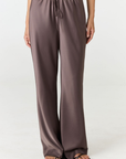 Experience ultimate comfort and sophistication with the Gia Silk Pants in brown by AOCO. These luxury trousers offer a flattering fit and an elegant, flawless drape.