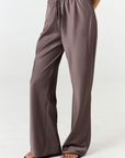 Experience ultimate comfort and sophistication with the Gia Silk Pants in brown by AOCO. These luxury trousers offer a flattering fit and an elegant, flawless drape.