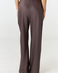 Experience ultimate comfort and sophistication with the Gia Silk Pants in brown by AOCO. These luxury trousers offer a flattering fit and an elegant, flawless drape.