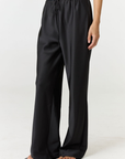 Experience ultimate comfort and sophistication with the Gia Silk Pants in black by AOCO. These luxury trousers offer a flattering fit and an elegant, flawless drape.
