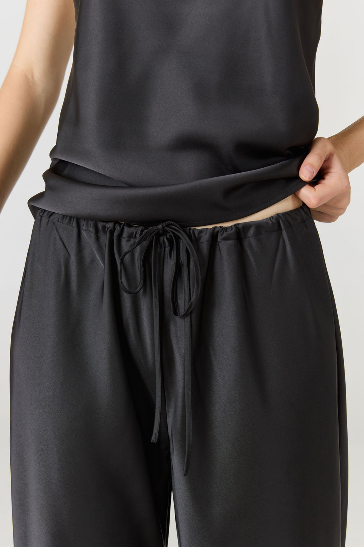 Experience ultimate comfort and sophistication with the Gia Silk Pants in black by AOCO. These luxury trousers offer a flattering fit and an elegant, flawless drape.