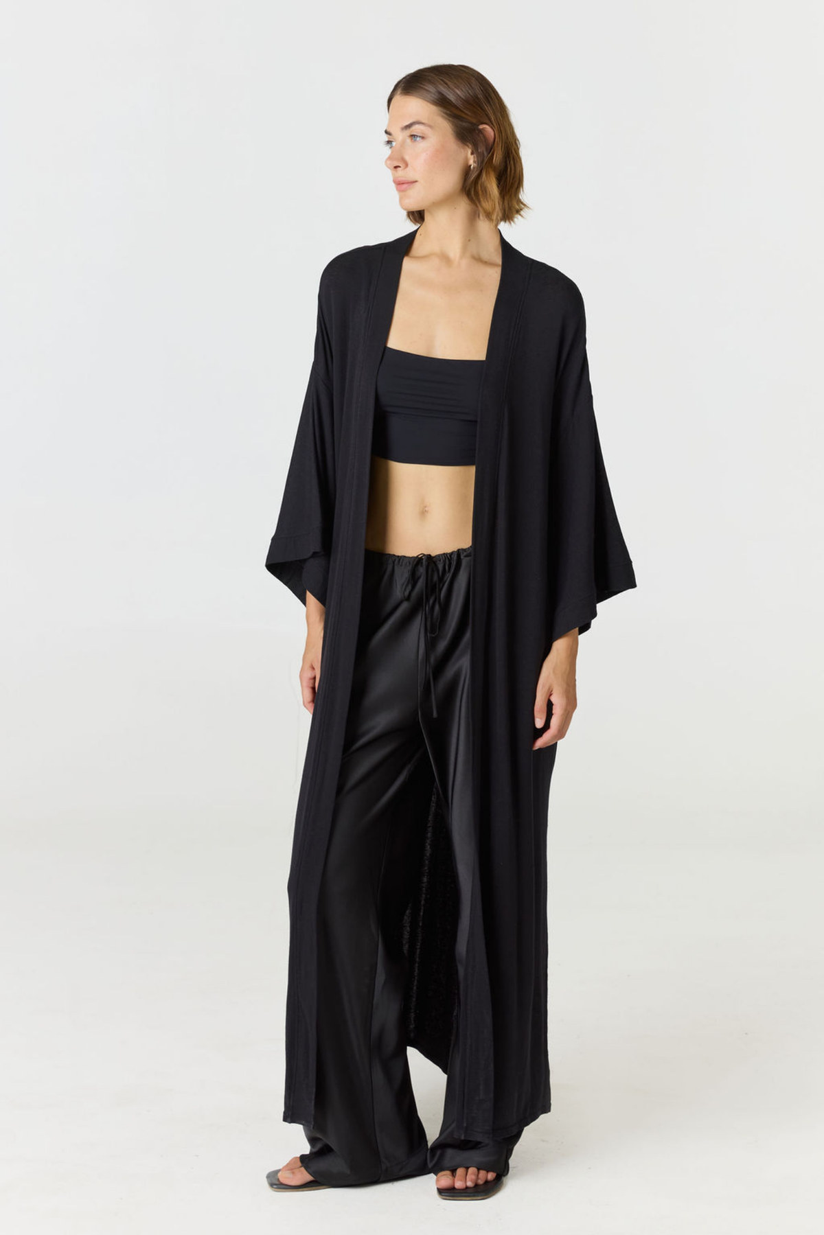 Experience ultimate comfort and sophistication with the Gia Silk Pants in black by AOCO. These luxury trousers offer a flattering fit and an elegant, flawless drape.