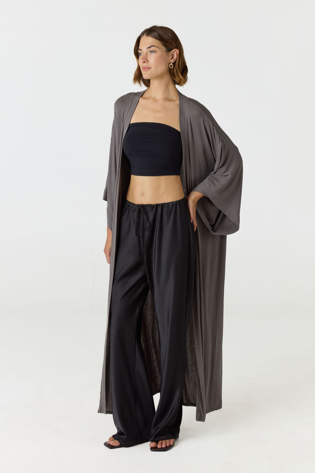 Experience ultimate comfort and sophistication with the Gia Silk Pants in black by AOCO. These luxury trousers offer a flattering fit and an elegant, flawless drape.