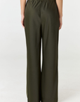 Experience ultimate comfort and sophistication with the Gia Silk Pants in olive by AOCO. These luxury trousers offer a flattering fit and an elegant, flawless drape.